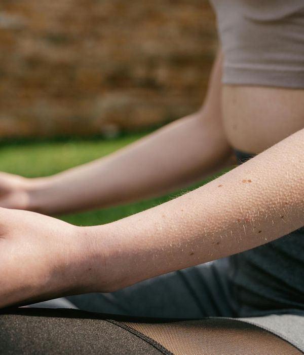 Woman in a calm, seated yoga posture, representing inner balance and focus.